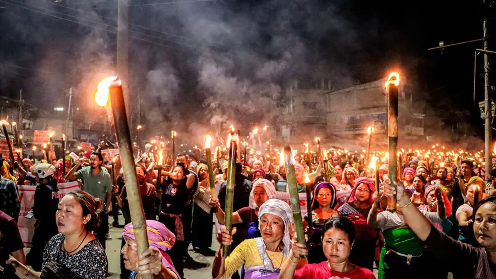 Meira paibis hold torches as they protest against the Tronglaobi killing incident at Khurai, in Imphal on Friday. (Image Credit: ANI Photo)